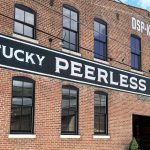 The facade of the Kentucky Peerless Distilling Co. building on a nice, summer day.