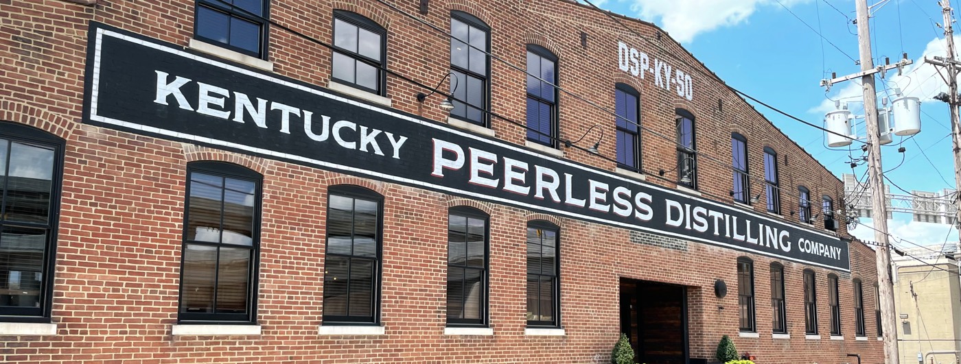 The facade of the Kentucky Peerless Distilling Co. building on a nice, summer day.