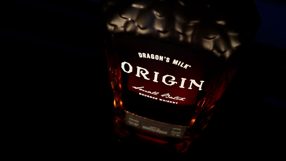 A closeup of the label on a bottle of Dragon's Milk Origin.